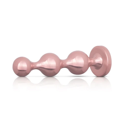 На фото розовый набор анальных игрушек Rosy Gold - Metal Butt Plug Set 3 Piec