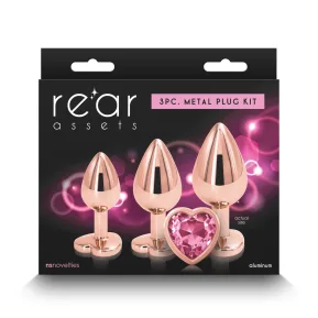 На фото набор анальных пробок NS Novelties Rear Assets - Trainer Kit - Rose Gold - Pink Heart