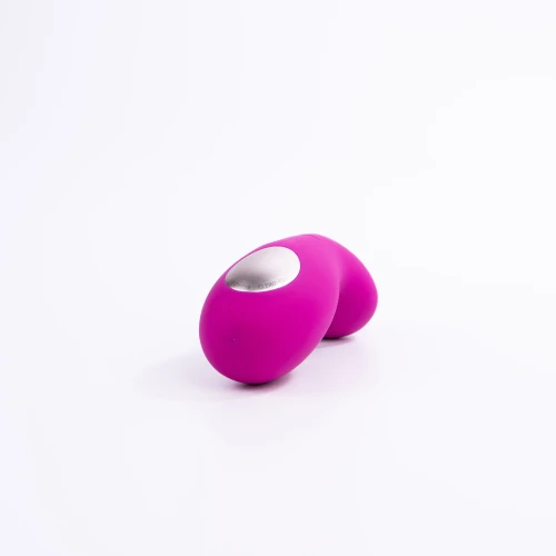 На фото зображено яскраво-рожевий вібратор, що знаходиться на відстані