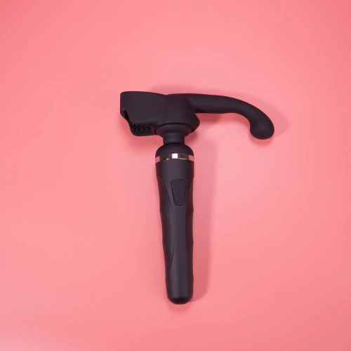 На фото изображена черная насадка Lovense Domi Male Attachment для вибраторов Domi и Domi 2 для мужчин на розовом фоне.