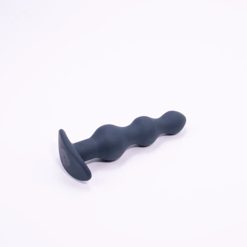 На фото изображена черная анальная вибропробка Dorcel DEEP SECRET M на светлом фоне