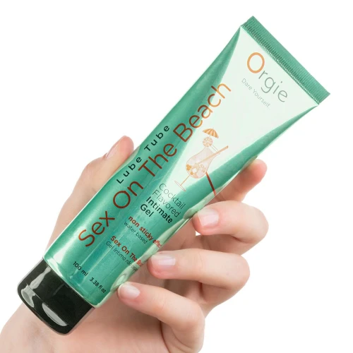 На фото изображен зеленый лубрикант на водной основе cо вкусом коктейля секс на пляже Orgie Lube Tube Sex On The Beach, 100 мл унисекс на белом фоне.