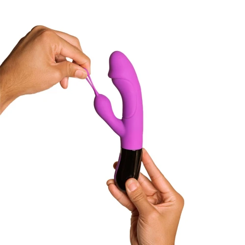 Фиолетовый вибратор-кролик Adrien Lastic Ares 2.0 с черными вставками на фото – с петелькой на отростке, держат в руке.