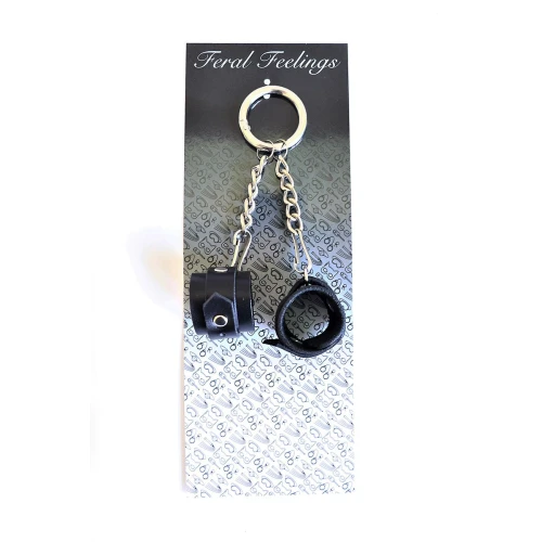 На фото изображен черный брелок наручники для ключей унисекс на светлом фоне