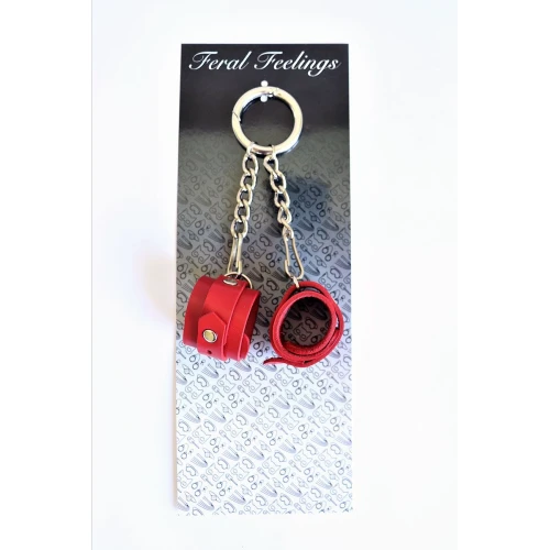 На фото зображено червоний брелок наручники для ключів унісекс на світлому фоні.