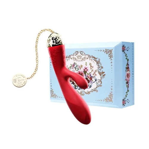На фото изображен красный вибратор-кролик с золотой цепочкой Zalo - Rosalie Bright Red для женщин на белом фоне.