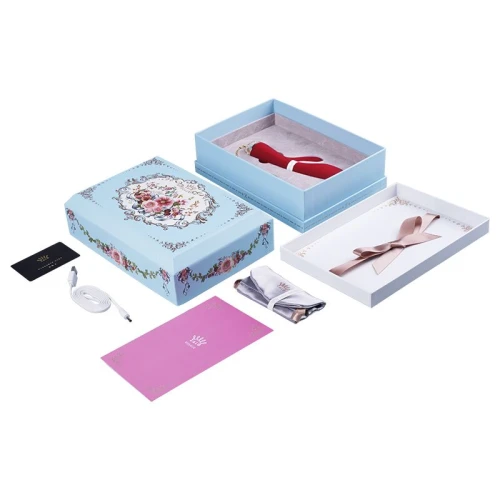 На фото изображен красный вибратор-кролик с золотой цепочкой Zalo - Rosalie Bright Red для женщин на белом фоне.