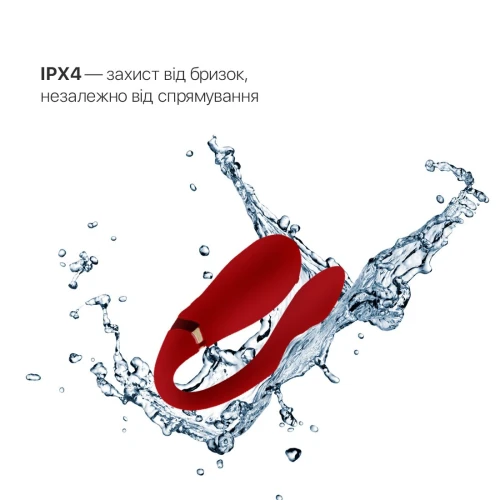 На фото изображен красный вибратор Zalo - Fanfan Bright Red для пар на белом фоне.