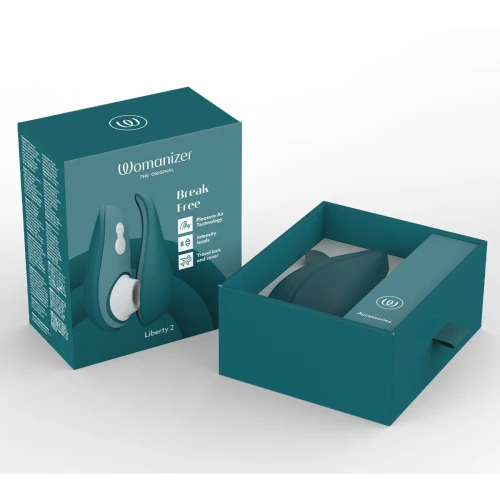 На фото изображен зеленый вакуумный стимулятор Womanizer Liberty 2 Dark Petrol для женщин на белом фоне.