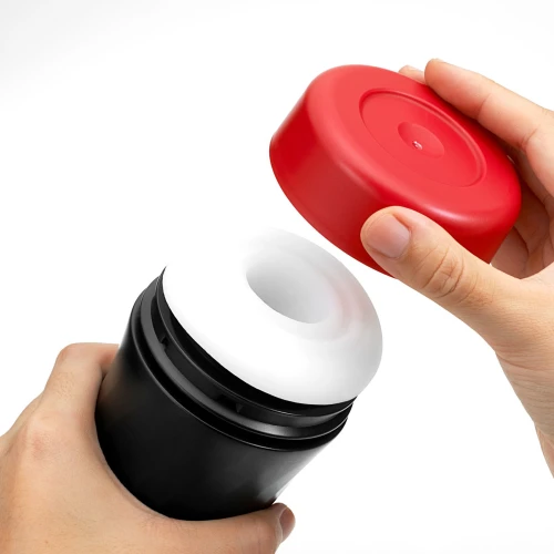 На фото изображен Tenga Air-Tech TWIST Ripple Red - Мастурбатор с реалистичным эффектом глубокого минета мужчин на светлом фоне 