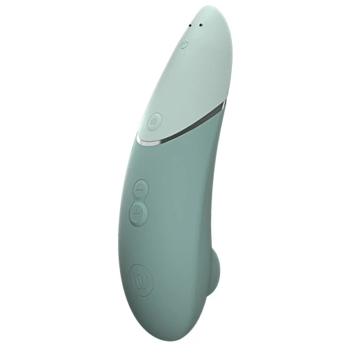 На фото изображен зеленый вакуумный стимулятор Womanizer Next Sage для женщин на белом фоне.