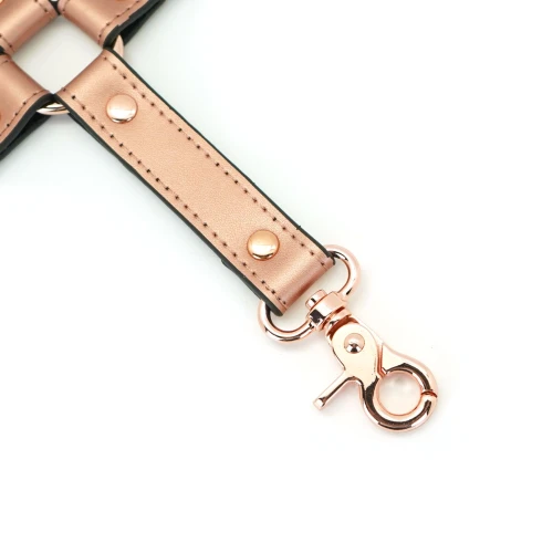 На фото зображено хрестовину для банджалу кольору рожевого золота Liese Seele Rose Gold Memory Hog Tie унісекс на білому тлі