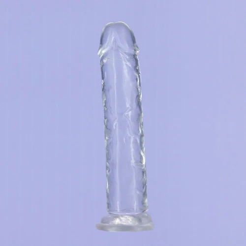 На фото изображен полупрозрачный фаллоимитатор из мягкого материала TPE на присоске ADDICTION - Crystal Vertical Dong 7” для женщин на фиолетовом фоне.