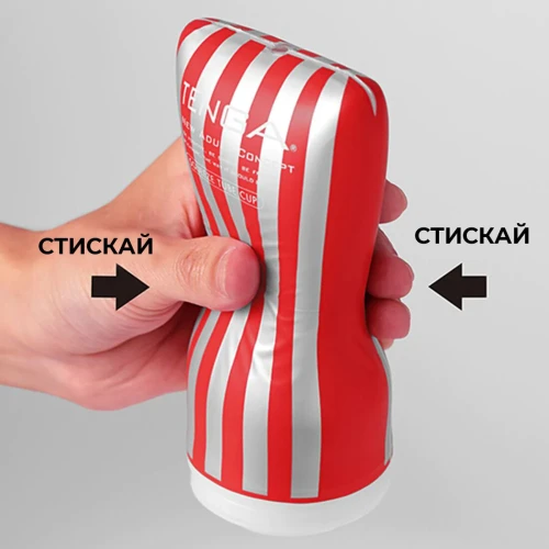 На фото зображено червоно-білий мастурбатор Tenga Squeeze Tube Cup для чоловіків на світлому фоні.