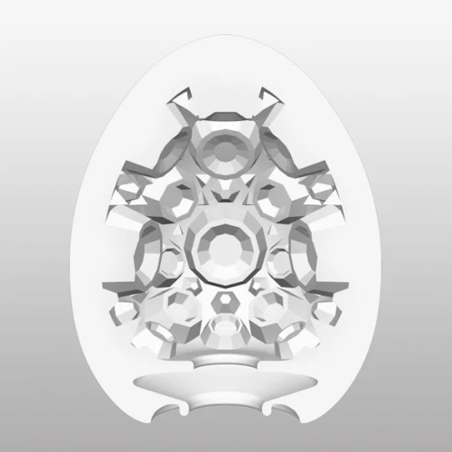 На цьому фото зображено біле яйце-мастурбатор Tenga Egg Crater для чоловіків на світлому фоні.