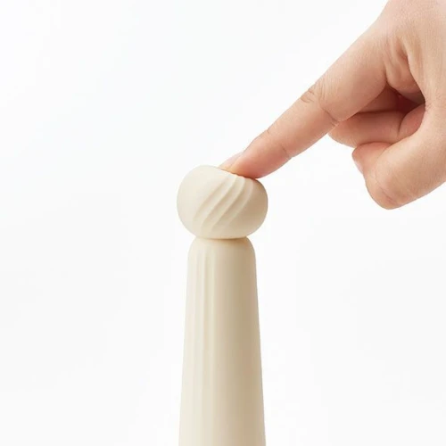 На фото изображен бежевый мини-вибратор с мягким кончиком IROHA RIN Akane для женщин на белом фоне.