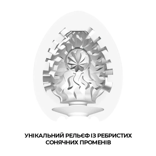 На этом фото изображено белое яйцо-мастурбатор Tenga Egg Shiny для мужчин на светлом фоне