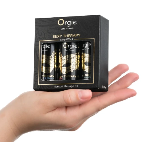 На фото зображено чорний набір масажних олій Orgie - Sexy Therapy Mini Size Collection (3х30 мл) для пар на білому тлі.