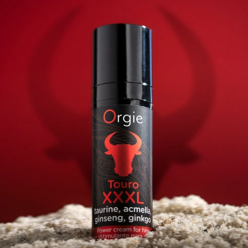 На фото зображено чорний крем для посилення ерекції Orgie Touro XXXL Power Cream, 15 мл, з ефектом вібрації для чоловіків червоному  тлі