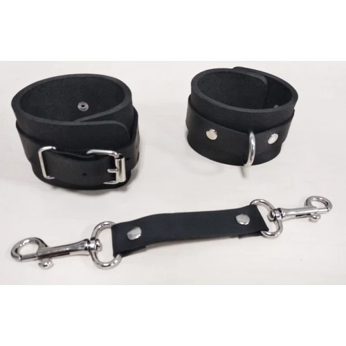 На фото зображені чорні наручники Feral Feelings - Hanis Restraints унісекс на білому тлі.