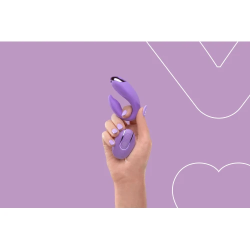 На фото зображено фіолетовий вібратор FairyGasm PleasureBerry violet для пар на фіолетовому тлі.