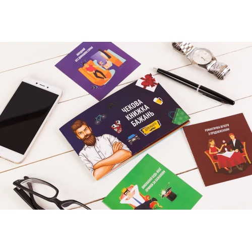 На фото изображена разноцветная чековая книжка желаний для него на светлом фоне