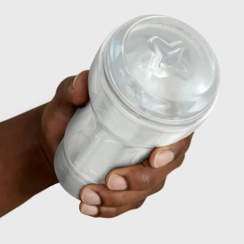 На фото изображен прозрачный мастурбатор Kiiroo Feel Pocket Crystal для мужчин на светлом фоне