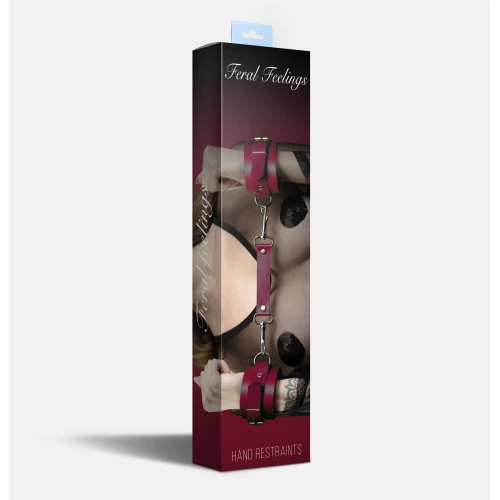 На фото зображено бордові шкіряні наручники БДСМ Feral Feelings - Hand Restraints у коробці унісекс на білому тлі