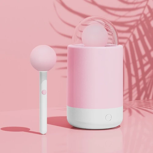 На фото зображено рожевий вібратор-цукерка KISTOY Pink Pop для жінок на рожевому тлі.