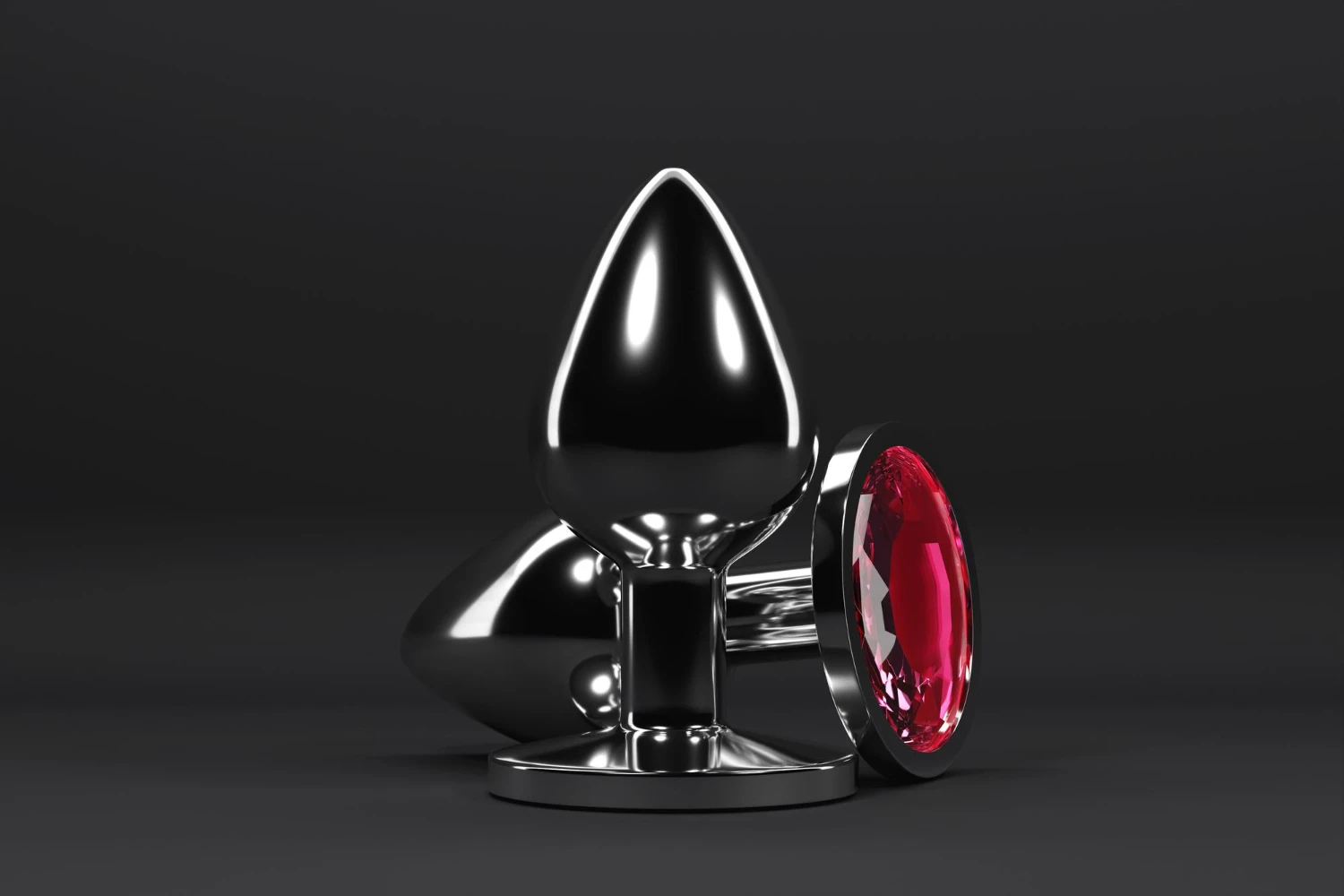 на темно сірому фоні зображена пробка з каменем анальна з білого металу