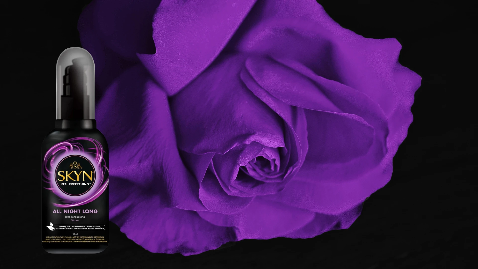на фото зображений силіконовий лубрикант Skyn на фоні фіолетової троянди