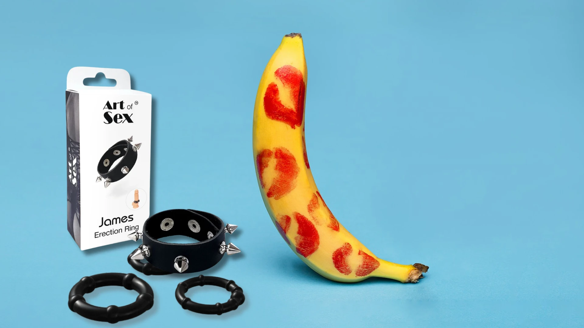 на фото зображено декілька видів ерекційних кілець чорного кольору та банан в поцілунках помадою на блакитному фоні