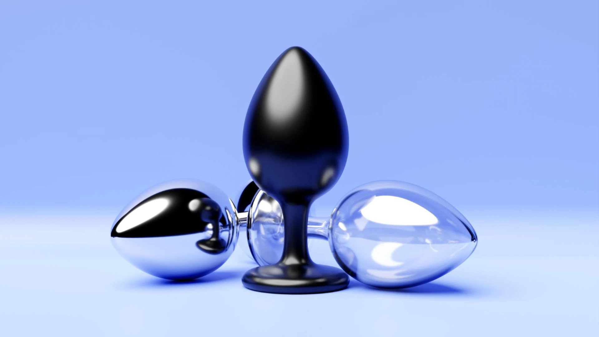 на голубом фоне изображен набор анальных пробок одного размера но разных цветов