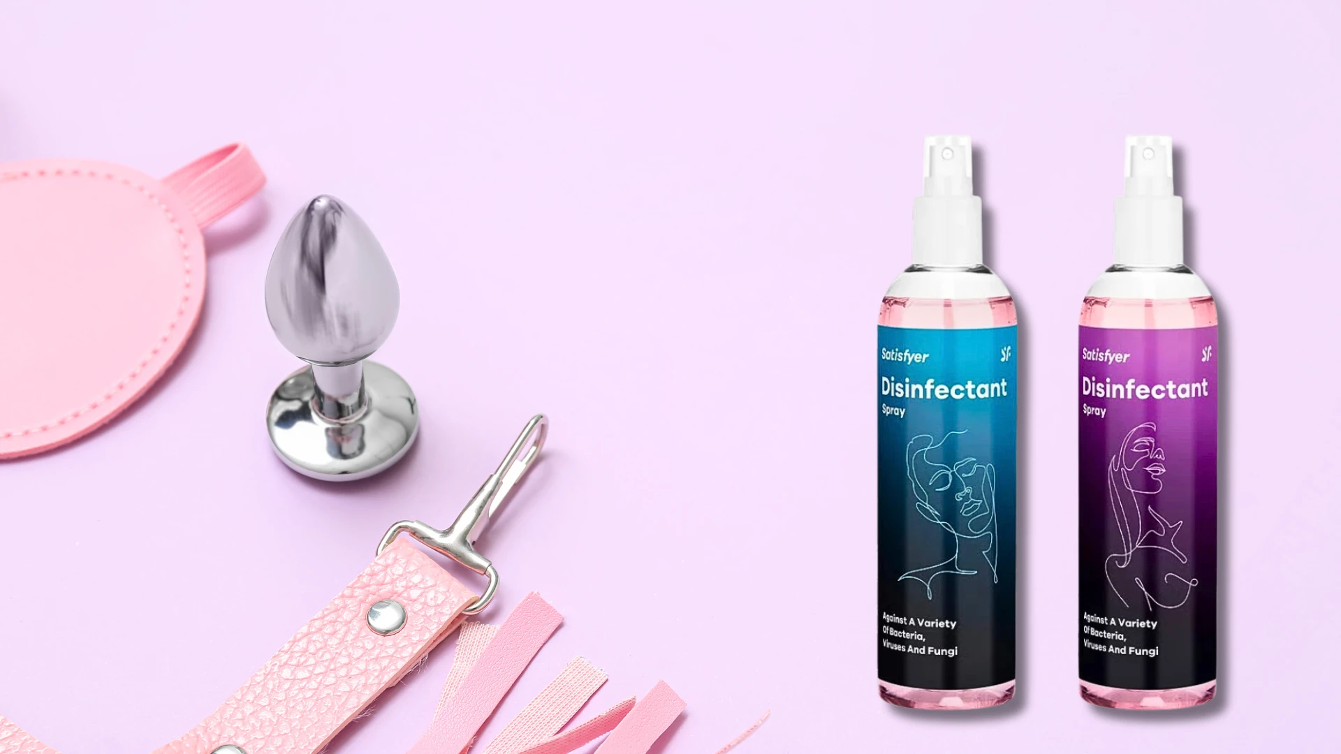 на фото два дезинфікуючі та очищувальні спреї Satisfyer на фоні секс іграшок та сиреньового кольору