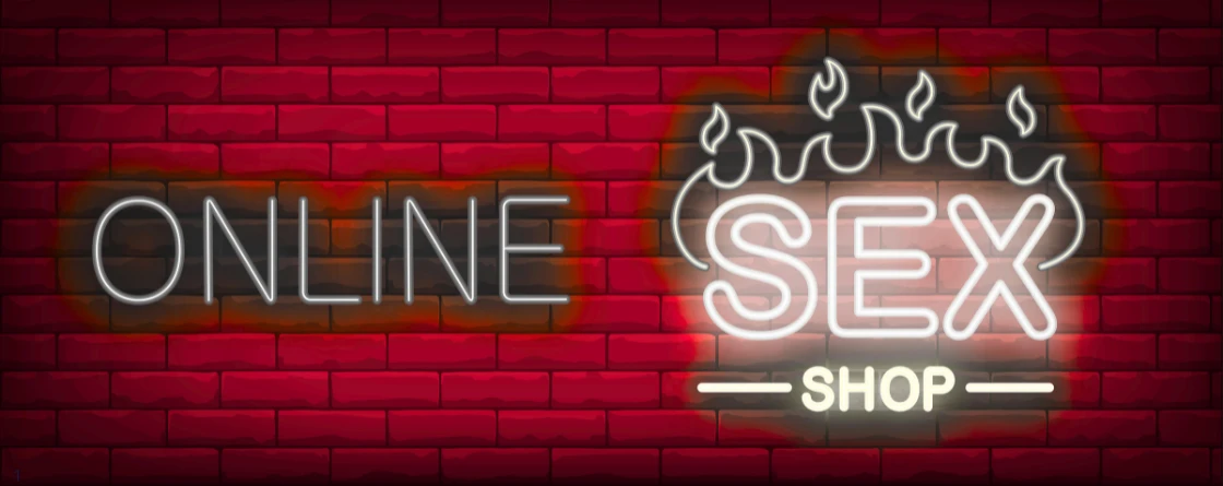 sex shop online надпись неоновая светящаяся на фоне красных кирпичей