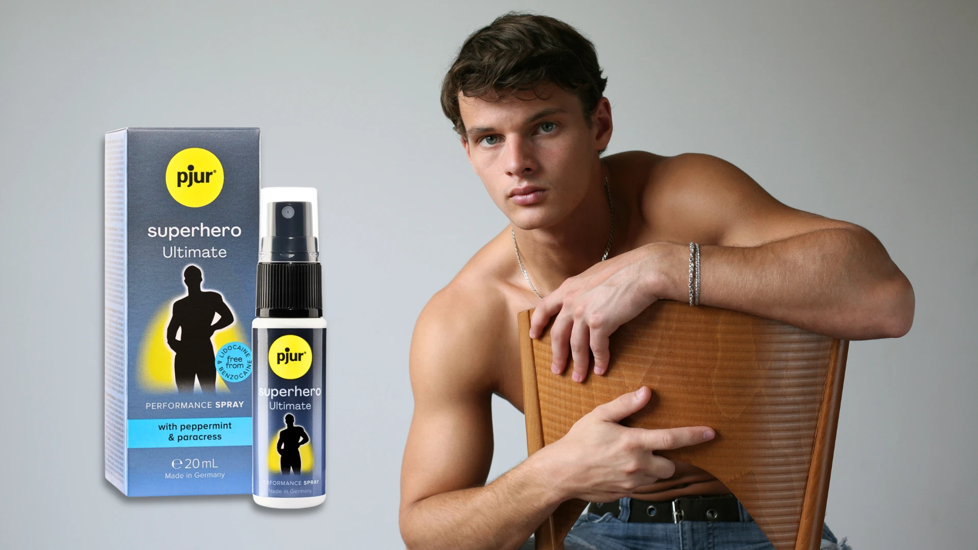 на фото изображено возбуждающее средство Pjur Superhero на фоне сексуального мужчины с оголеным торсом